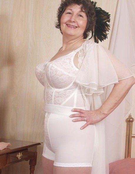 Busty mature Danica in open girdle and stockings.